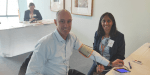 Pharmacist Bev Mistry-Cable tests Senator David Van from Victoria for an irregular heartbeat
