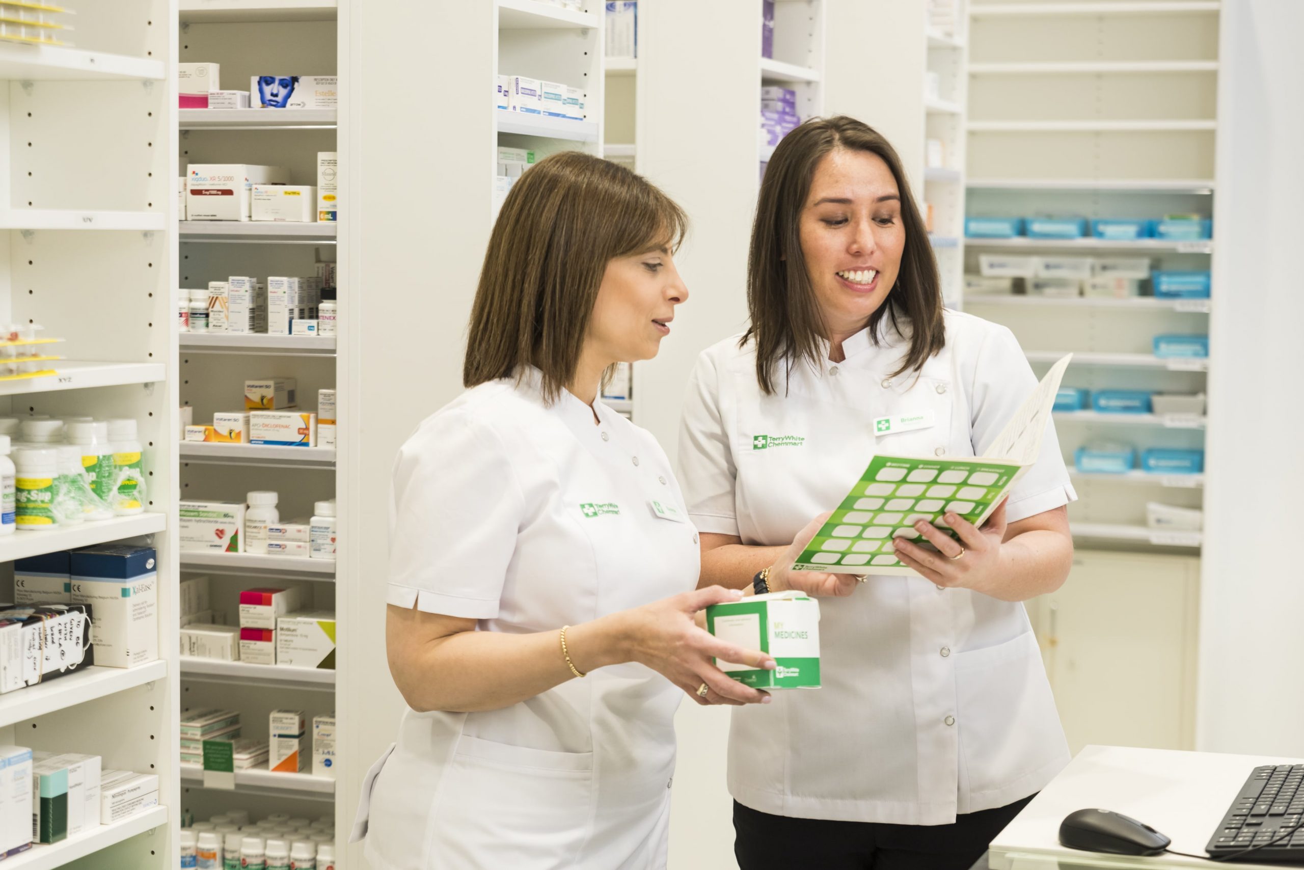 two-pharmacists-looking-at-medical-prescription-at-terrywhite-chemmart ...