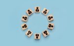 round table concept, business meeting. businessmen icons on wooden cubes arranged in circle. discussion of important issues, round table talks. pluralism of opinions